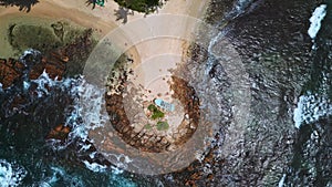 Overhead shot unveils old, beached boat overfilled with plastic refuse, dire marine pollution plaguing scenic shores