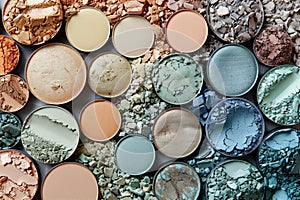 Overhead shot of various crushed eyeshadows in an array of colors, perfect for beauty and cosmetics advertising, makeup