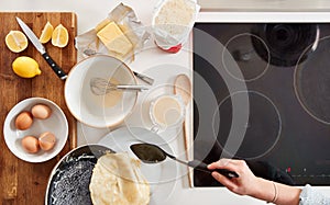 Overhead Shot Of Woman In Kitchen Serving Pancakes Or Crepes For Pancake Day