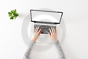 Overhead shot of woman working on laptop with copyspace