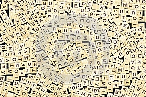 Overhead shot of wordplay wooden cubes scattered on a dark surface