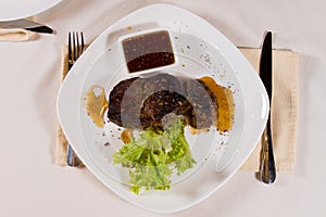 Overhead of Steak on Plate with Garnish