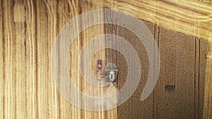 Overhead top down view of agricultural machinery in harvest season