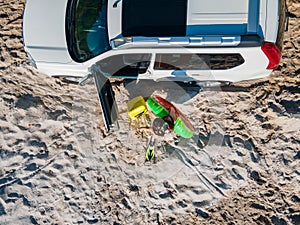 overhead top view happy woman getting out from the car in flippers with inflatable ring and bag