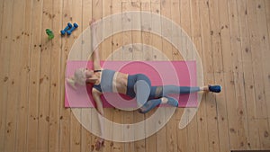Overhead view of active sporty fit mature woman practicing yoga stretch exercise