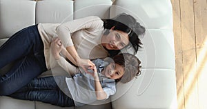 Overhead view Asian mom son making heart shape with fingers