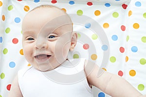 Overhead View Of Baby Girl Lying On Colorful Change Mat