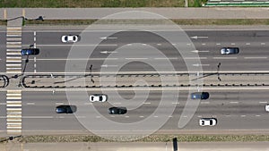 Overhead view of black and white cars moving along the multilane highway