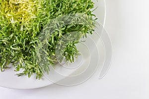 Overhead view of bowl of frisee lettuce, copy space, isolated on white