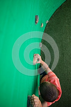 Overhead view of boy climbing on wall