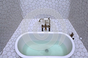 overhead view of a bubble bath in a clawfoot tub