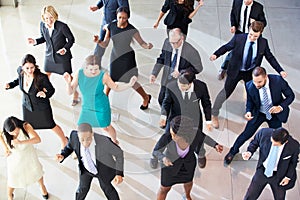 Overhead View Of Businesspeople Dancing In Office Lobby