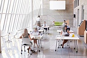 Overhead View Of Businesspeople Working At Desks In Office