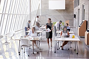 Overhead View Of Businesspeople Working At Desks In Office