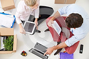 Overhead View Of Businesspeople Working At Laptop