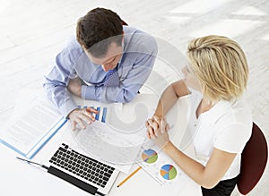 Overhead View Of Businesswoman And Businessman Working At Desk Together