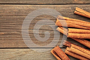 Overhead view of cinnamon sticks dried tree bark spice. Cinnamon on grey wooden background