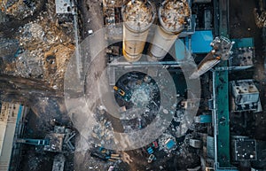 Overhead view of a cluttered industrial waste site with scattered debris and machinery.