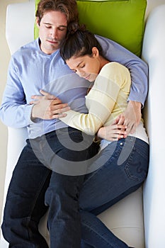 Overhead View Of Couple Relaxing On Sofa