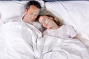 overhead view of couple sleeping in bed photo