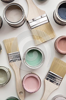 Overhead view of a DIY paint brush with colorful sample paint pots