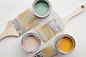 Overhead view of a DIY paint brush with colorful sample paint pots