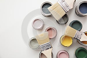 Overhead view of a DIY paint brush with colorful sample paint pots