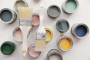 Overhead view of a DIY paint brush with colorful sample paint pots