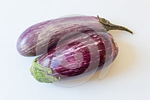 Overhead view of Dominican eggplants Solanum melongena food ingredients, isolated on white, horizontal aspect