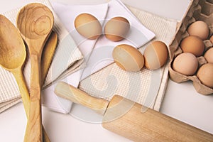 Overhead view of eggs and kitchen tools on table