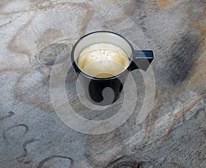 Overhead view of an espresso cup of freshly brewed coffee.