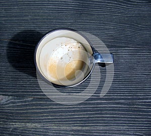 Overhead view of an espresso cup of freshly brewed coffee.