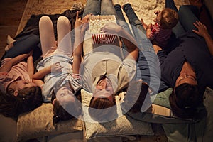 Overhead View Of Family Enjoying Movie Night At Home Together