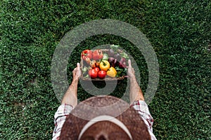 Farmer holding basket with vegetables