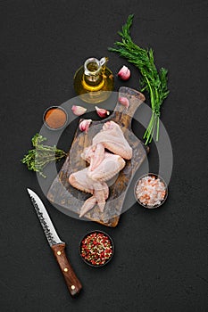 Overhead view of fresh uncooked chicken wings on cutting board ready for cooking