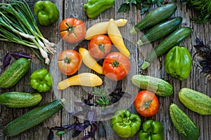 Overhead view of freshly picked produce on old wood background.