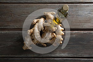 Overhead view of gingers by oil bottle on table