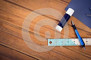 Overhead view of glue stick and pencil with ruler