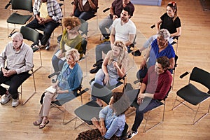 Overhead View Of Group Attending Neighborhood Meeting In Community Center