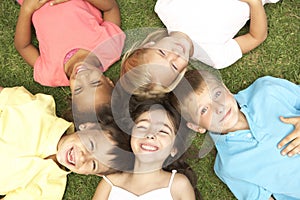 Overhead View Of Group Of Children Smiling At Camera