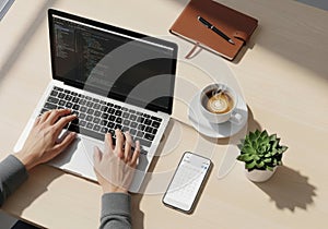 Person coding on a laptop with coffee and a notebook
