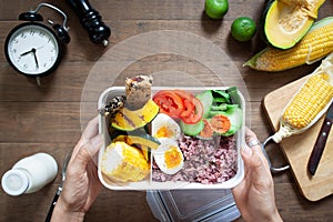 Overhead view of healthy lunch box with rice berry, boiled eggs