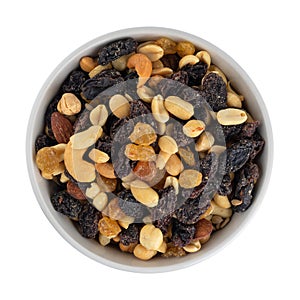 Overhead view of high energy trail mix with roasted nuts and fruit in a colorful bowl isolated on a white background