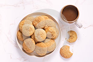 Overhead view of homemade snickerdoodle cookies with a cup coffee