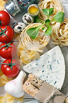 Overhead view of ingredients for an Italian pasta recipe on rust