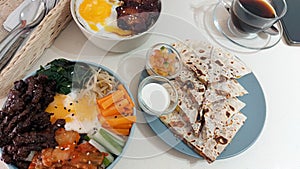 Overhead view of jeyuk deopbap,Bulgogi bibimbap or korean rice bowl and quesadilla