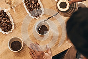 overhead view of man pouring hot water into bowl