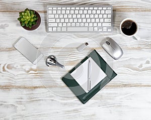 Overhead view of modern technology devices on white wooden board