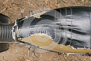 Overhead view of old and ripped motorbike seat with visible foam, detail and closeup of damaged motorcycle seat