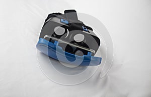 An overhead view of an opened VR head set against a white background